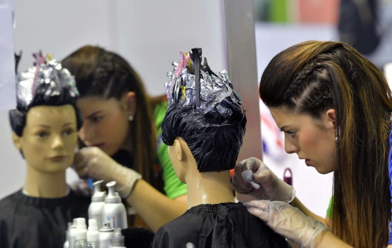 A competitor takes part in a hairdressing competition during the WorldSkills Abu Dhabi 2017 gathering in the oil-rich emirate on October 18, 2017