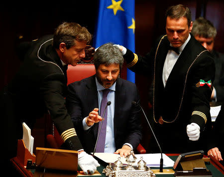 Assistants check the microphone of the new Chamber of Deputies president Roberto Fico at the Chamber of Deputies during the second session day since the March 4 national election in Rome, Italy March 24, 2018. REUTERS/Tony Gentile