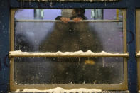 A commuter rides a tram during a snow storm, Feb. 5, 2020, in Sapporo, Hokkaido, Japan. (AP Photo/Jae C. Hong)