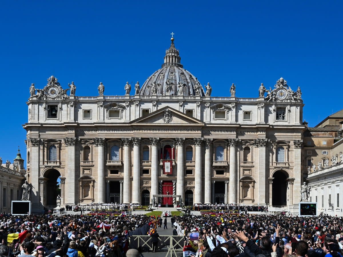 File photo: People wait below St Peter’s basilica at St Peter’s square, for the Pope to deliver the Urbi et Orbi message and blessing for Easter on 9 April 2023 in The Vatican (AFP via Getty Images)