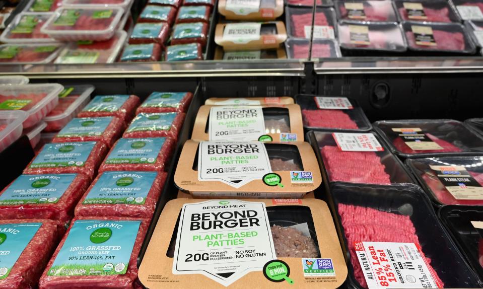 Beyond Meat "Beyond Burger" patties made from plant-based substitutes for meat products sit alongside various packages of ground beef for sale on November 15, 2019 in New York City. - Vegetarian alternatives to burgers and sausages, revived by start-ups like Beyond Meat and Impossible Burger, are enjoying a certain enthusiasm that meat giants also want to enjoy. Since this summer, the world leader in the JBS sector has been marketing a soy burger in Brazil that includes beetroot, garlic and onions, with a look similar to a rare minced steak. In the US, the largest meat producer Tyson Foods launched a new line of products in June based on plants or mixing meat and vegetables. Its competitors Hormel Foods, Perdue Farms or Smithfield, have similar initiatives. (Photo by Angela Weiss / AFP) (Photo by ANGELA WEISS/AFP via Getty Images)