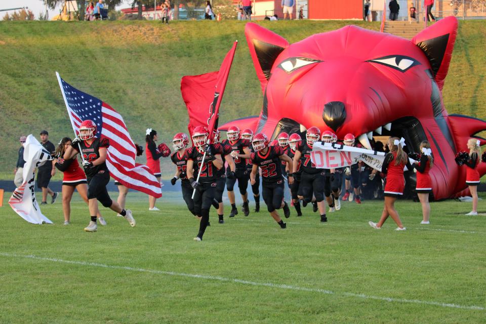 The Clinton football team runs out onto the field for its first home game of the season Friday against Blissfield.