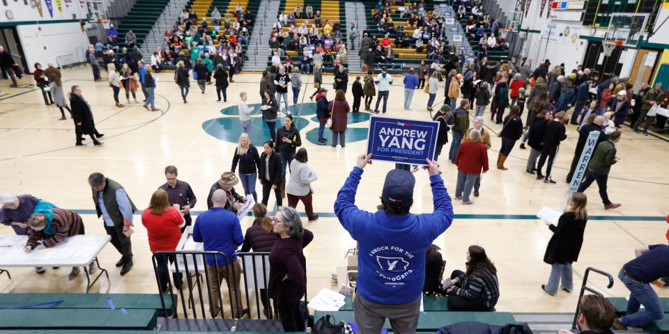 A supporter for Democratic presidential candidate businessman Andrew Yang waits in the stands before a Democratic caucus at Hoover High School, Monday, Feb. 3, 2020, in Des Moines, Iowa. (AP Photo/Charlie Neibergall)