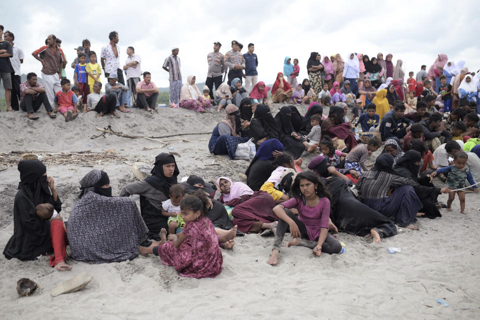 FILE - Ethic Rohingya people rest on Lampanah Leungah beach after landing in Aceh Besar, Aceh province, Indonesia, on Feb. 16, 2023. A dramatic story of survival and rescue off the western coast of Indonesia’s Aceh province has put the spotlight again on the plight of ethnic Rohingya Muslim refugees from Myanmar who make extremely dangerous voyages across the Indian Ocean to seek better lives. (AP Photo/Riska Munawarah, File)