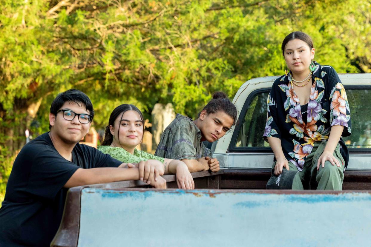 Four characters from the series Reservation Dogs in and around the back of a pickup truck.