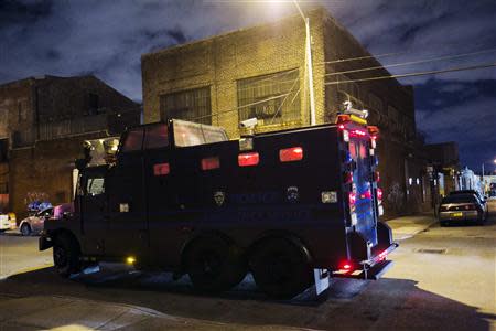 New York Police Department officers arrive in a tactical vehicle on the scene of a multiple shooting crime scene on Maujer Street in the Brooklyn borough of New York, November 11, 2013. REUTERS/Lucas Jackson