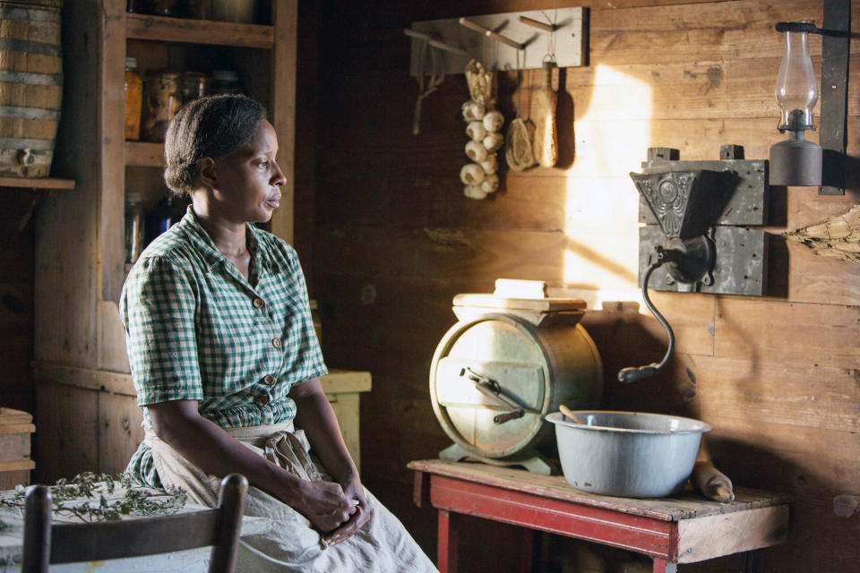 Mary J. Blige sits in an old timey kitchen