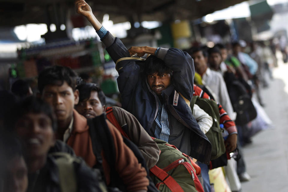 Indians crowd a platform to board a train in New Delhi, India.