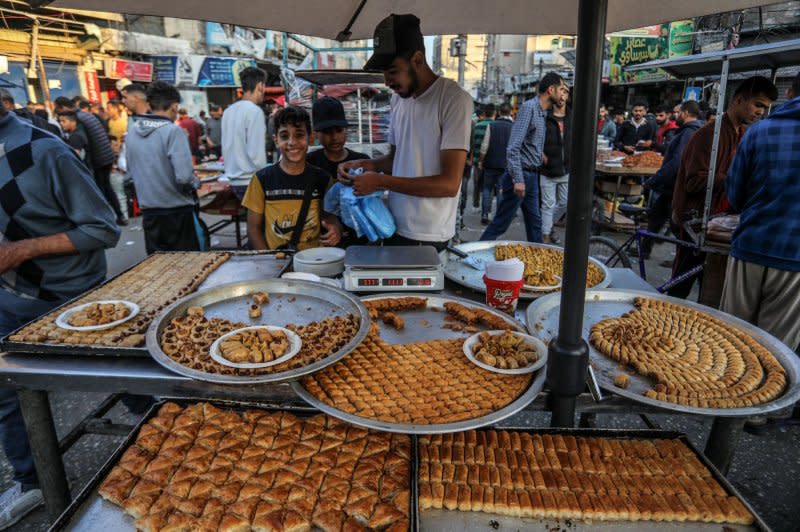 Street vendors sell sweets at a popular market in Rafah for this week's Muslim Eid al-Fitr celebrations, amid Israel's war against Hamas in the Gaza Strip. Photo by Ismael Mohamad/UPI