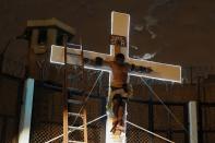 An inmate depicting Jesus performs the crucifixion scene in the theatre play "Jesus Christ Superstar" at Sarita Colonia prison yard, ahead of Holy Week celebrations, in Lima April 15, 2014. The play was held to encourage the inmates in their rehabilitation process, according to the prison's press release. Sarita Colonia's population is made up of 3,113 inmates, out of which 472 are foreigners. Picture taken April 15, 2014. REUTERS/Enrique Castro-Mendivil (PERU - Tags: RELIGION CRIME LAW TPX IMAGES OF THE DAY)