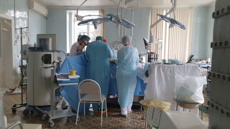 Doctors and nurses perform a surgery at a hospital in Blagoveshchensk