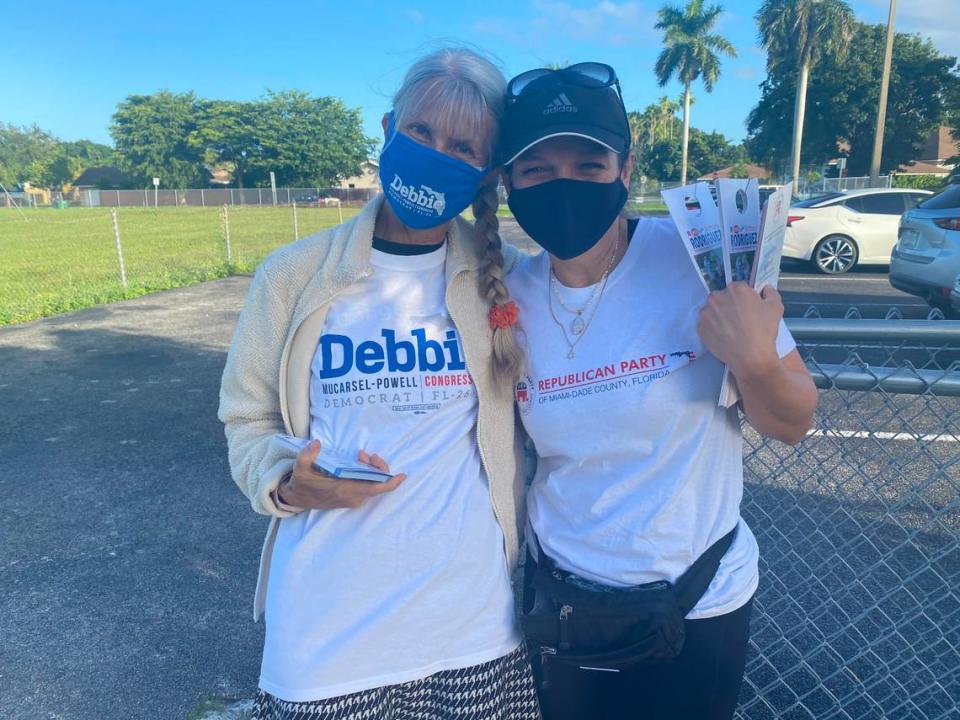 Anne Smith, a Democratic volunteer (left) and Marissa Gutierrez, a Republican volunteer (right) hug it out at Calusa Elementary School in West Kendall, one of the community’s Election Day precincts on Nov. 3, 2020.