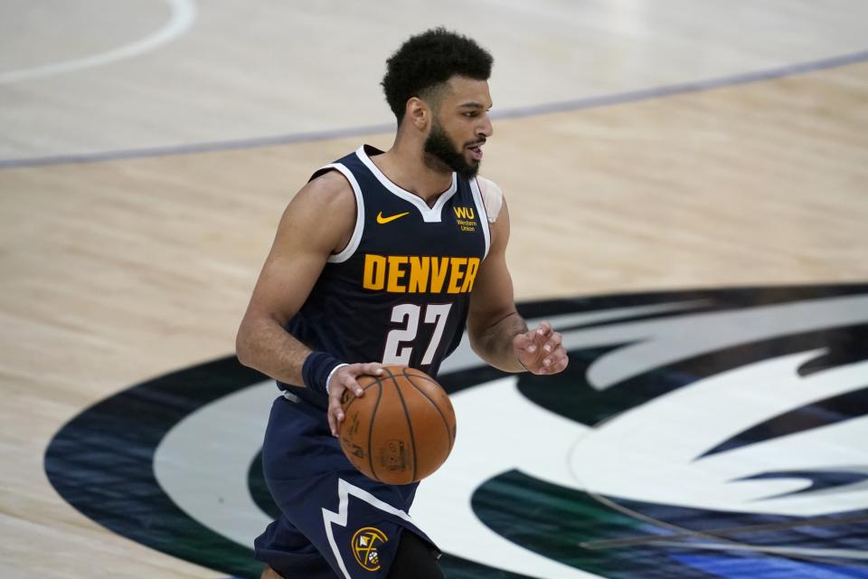 Denver Nuggets guard Jamal Murray (27) advances the ball against the Dallas Mavericks in the second half of an NBA basketball game in Dallas, Monday, Jan. 25, 2021. (AP Photo/Tony Gutierrez)