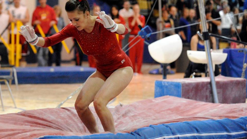 Gymnast landing on soft mats