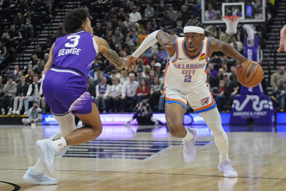 Oklahoma City Thunder guard Shai Gilgeous-Alexander (2) drives against Utah Jazz guard Keyonte George (3) during the first half of an NBA basketball game Thursday, Jan. 18, 2024, in Salt Lake City. (AP Photo/Rick Bowmer)