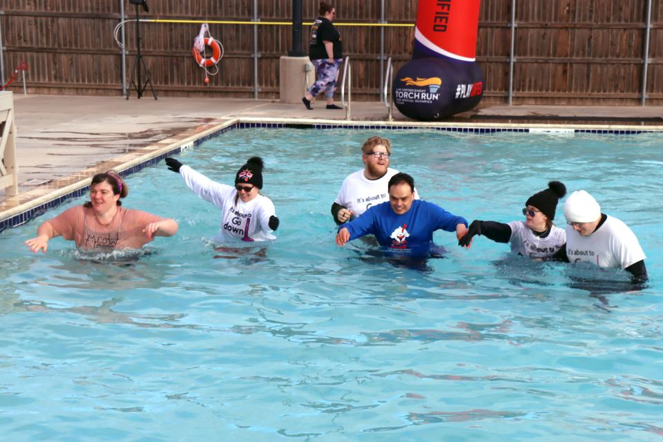 Athletes from Advo make their way through 31-degree water during the annual Special Olympics Polar Plunge held at Amarillo Town Club on Hillside Saturday morning.