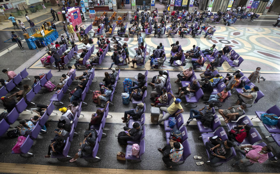 Passengers sit in waiting room at Hua Lamphong Railway Station in Bangkok, Thailand, Friday, April 9, 2021. Thai authorities were struggling Friday to contain a growing coronavirus outbreak just days before the country's traditional Songkran New Year's holiday, when millions of people travel around the country. (AP Photo/Sakchai Lalit)