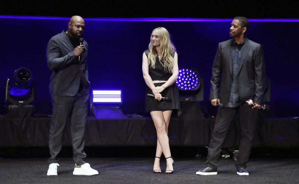 Antoine Fuqua, left, director of the upcoming film "The Equalizer 3," is joined by cast members Dakota Fanning, center, and Denzel Washington onstage during the Sony Pictures presentation at CinemaCon 2023, the official convention of the National Association of Theatre Owners (NATO) at Caesars Palace, Monday, April 24, 2023, in Las Vegas. (AP Photo/Chris Pizzello)