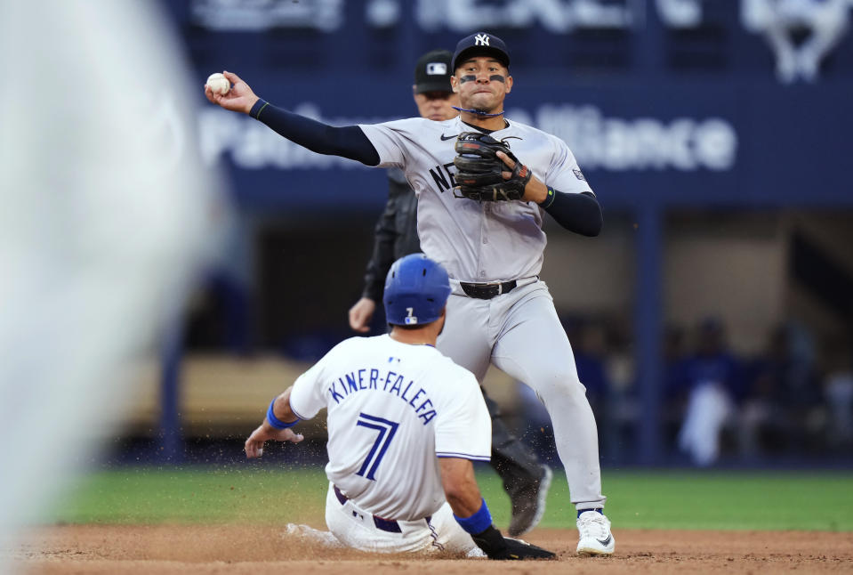 New York Yankees second baseman Jahmai Jones throws to first after forcing out Toronto Blue Jays' Isiah Kiner-Falefa (7) on a double play hit into by Vladimir Guerrero Jr. during the fourth inning of a baseball game Thursday, June 27, 2024, in Toronto. (Frank Gunn/The Canadian Press via AP)