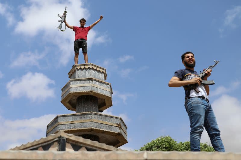 Fighters loyal to Libya's internationally recognised government celebrate after regaining control over Tarhouna city