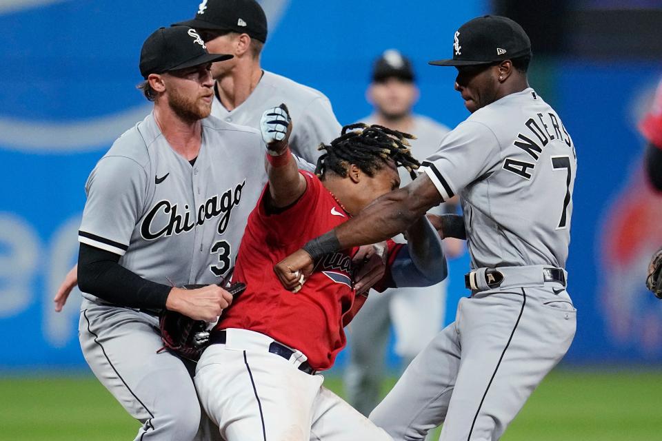 White Sox pitcher Michael Kopech, left, holds Guardians third baseman Jose Ramírez, center, as White Sox shortstop Tim Anderson throws a punch during the sixth inning Saturday.