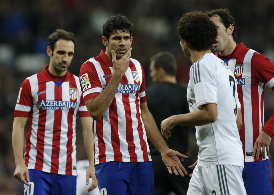 Atletico's Diego Costa, 2nd left has words with Real's Pepe, 3rd right during a semi final, 1st leg, Copa del Rey soccer derby match between Real Madrid and Atletico Madrid at the Santiago Bernabeu Stadium in Madrid, Wednesday Feb. 5, 2014. (AP Photo/Paul White)