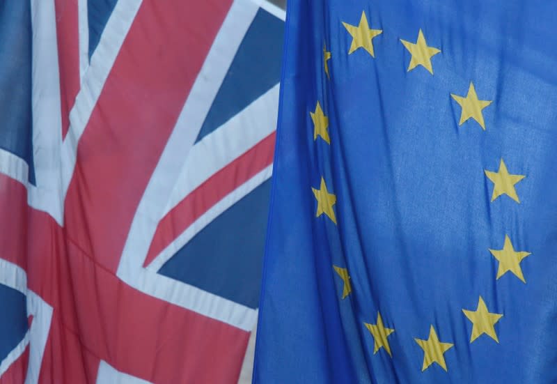 FILE PHOTO: A Union flag flies next to the flag of the European Union in Westminster, London