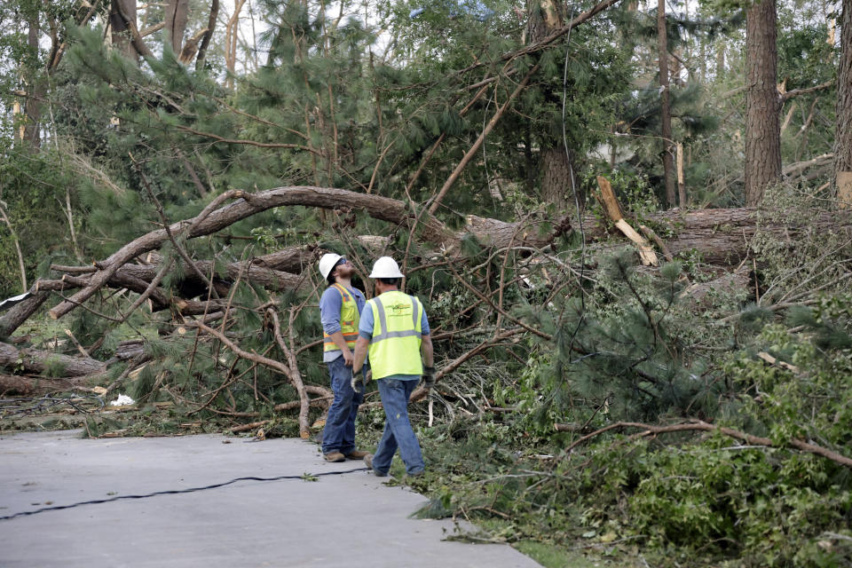 Utility crews survey damage caused by a tornado on Wednesday, July 19, 2023, on Town Hall Rd., in Dortches, N.C. (AP Photo/Chris Seward)