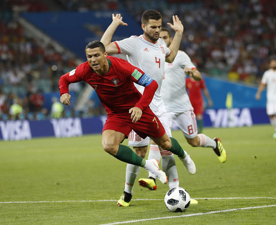 <p>Portugal’s Cristiano Ronaldo, left, is fouled by Spain’s Nacho for a penalty during the Group B match between Portugal and Spain. (AP) </p>