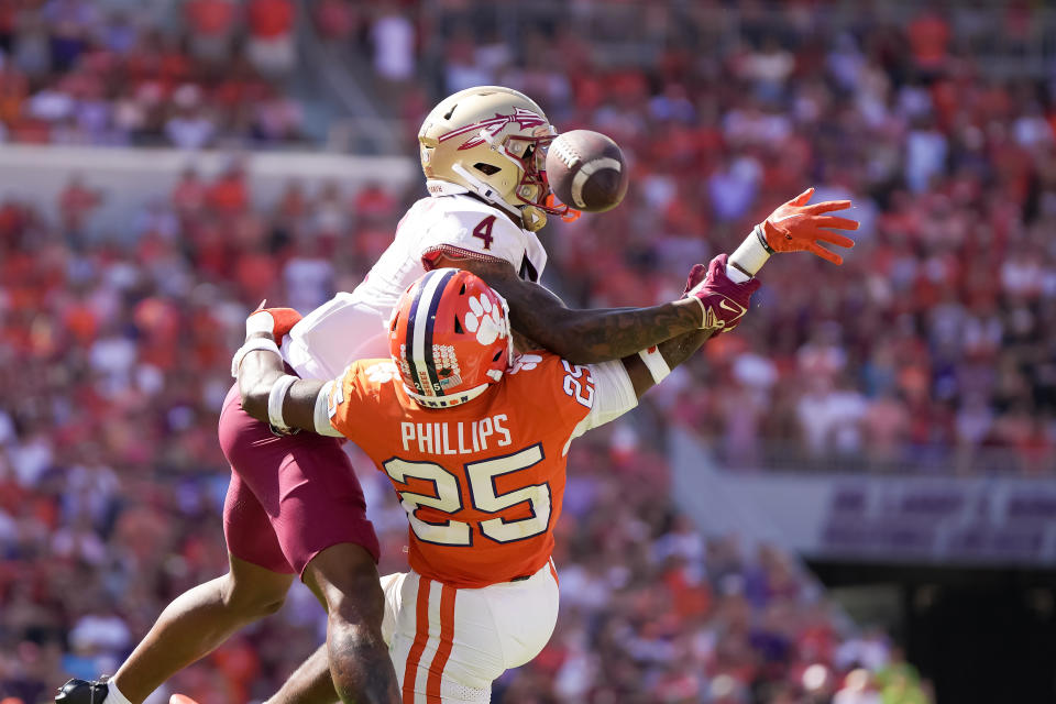 Sep 23, 2023; Clemson, South Carolina, USA; Clemson Tigers safety Jalyn Phillips (25) disrupts a pass intended for Florida State Seminoles wide receiver <a class="link " href="https://sports.yahoo.com/ncaaf/players/326536/" data-i13n="sec:content-canvas;subsec:anchor_text;elm:context_link" data-ylk="slk:Keon Coleman;sec:content-canvas;subsec:anchor_text;elm:context_link;itc:0">Keon Coleman</a> (4) in the second half at Memorial Stadium. Mandatory Credit: David Yeazell-USA TODAY Sports