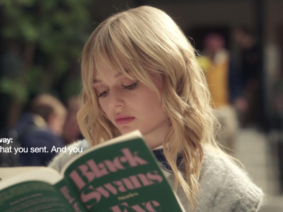 Emily Alyn Lind reading a book on episode two of "Gossip Girl."