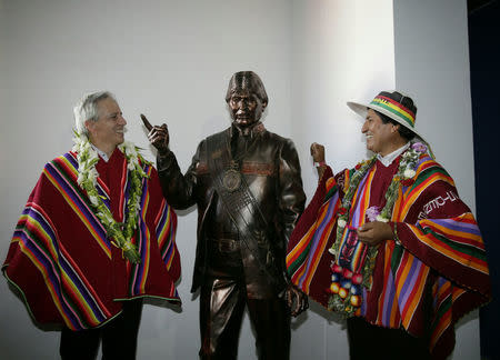 Bolivia's President Evo Morales (R) and Vice President Alvaro Garcia Linera pose with a statue of Morales after the inauguration of the Orinoca Museum in Orinoca, Bolivia February 2, 2017. REUTERS/David Mercado