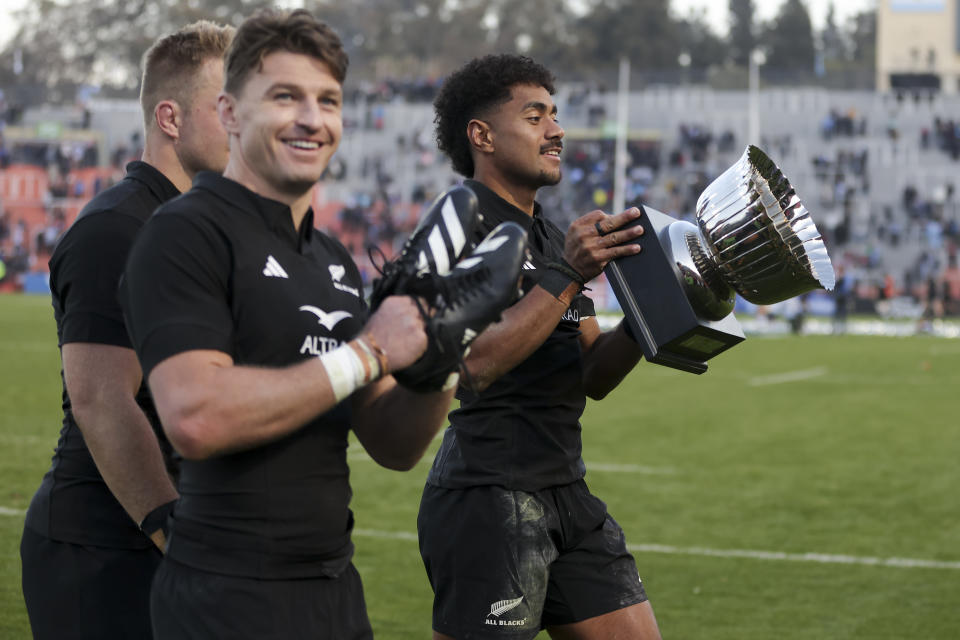 New Zealand's All Blacks Emoni Narawa holds the trophy after winning a rugby championship match against Argentina's Los Pumas at Malvinas Argentinas stadium in Mendoza, Argentina, Saturday, July 8, 2023. (AP Photo/Nicolas Aguilera)