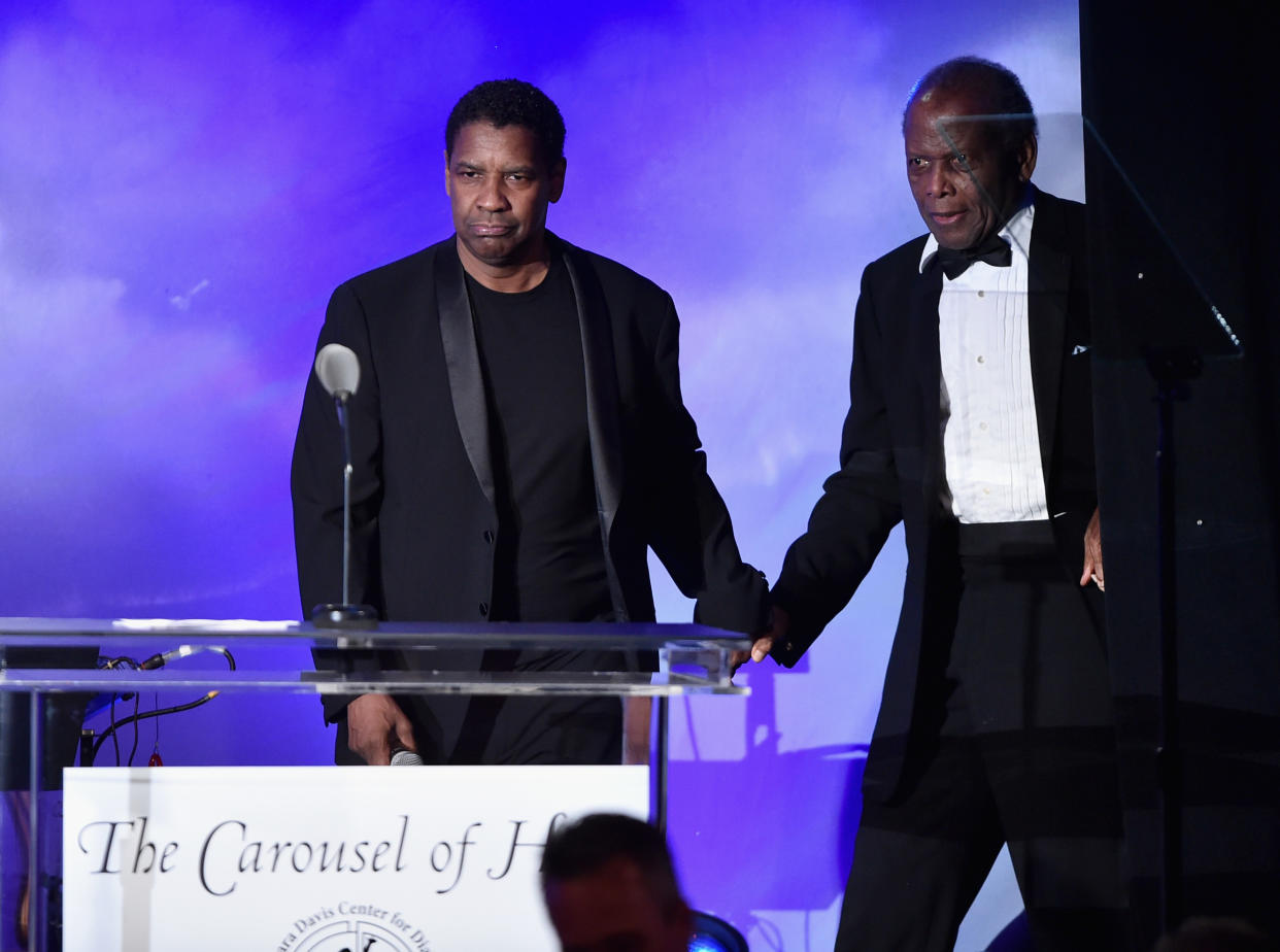 BEVERLY HILLS, CA - OCTOBER 08:  Actor Denzel Washington (L) and Inspirational Lifetime Achievement Award Recipient Sidney Poitier speak onstage during the 2016 Carousel Of Hope Ball at The Beverly Hilton Hotel on October 8, 2016 in Beverly Hills, California.  (Photo by Alberto E. Rodriguez/Getty Images)