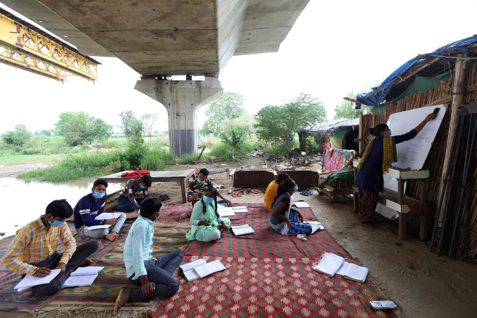 Students in Class 10 who do not have access to the internet and cannot afford electronic devices to attend to online classes study in an open-air class in a slum organized by Satyendra Pal Shakya, a college student, as schools remain closed on July 20 in New Delhi.