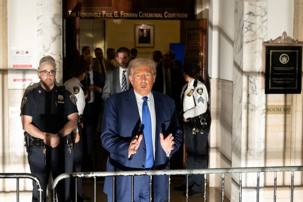 Donald Trump speaks to reporters steps away from Judge Arthur Engoron’s courtroom on 25 October.  (REUTERS)