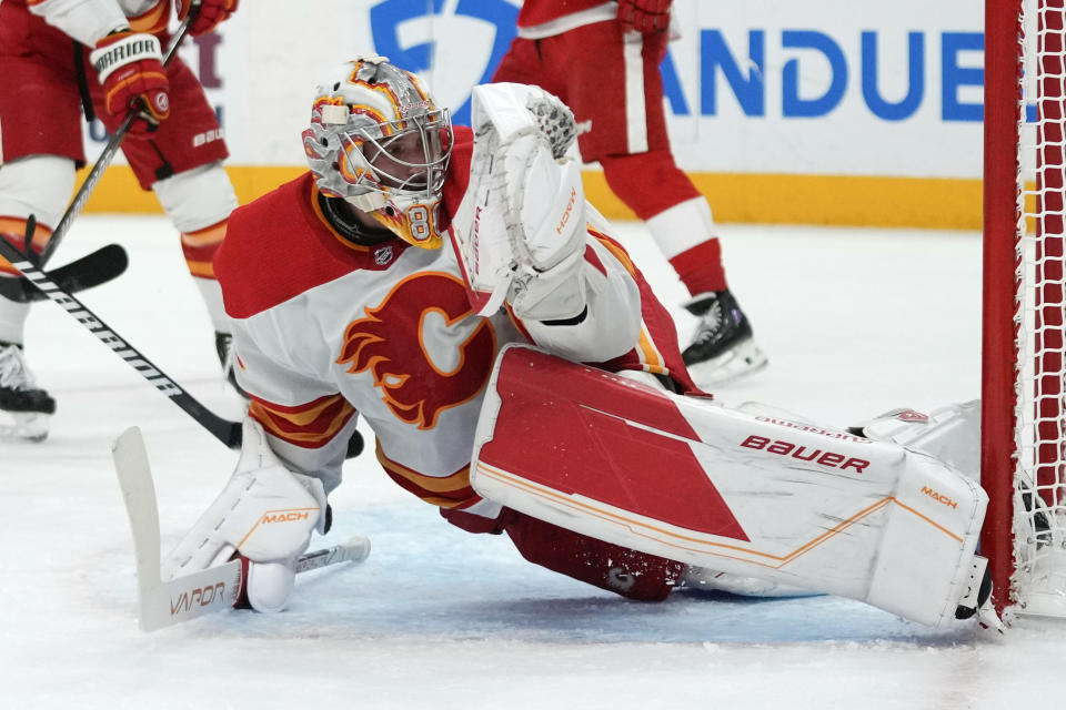 Calgary Flames goaltender Dan Vladar (80) stops a Detroit Red Wings shot in the first period of an NHL hockey game Sunday, Oct. 22, 2023, in Detroit. (AP Photo/Paul Sancya)
