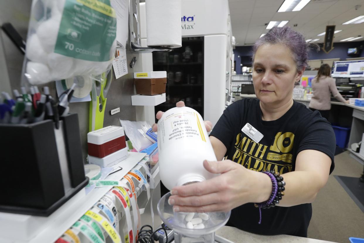 Certified Pharmacy Technician Kathy Zimmermann counts pills for a prescription at Smith Pharmacy Wednesday, December 20, 2023, in Little Chute, Wis.