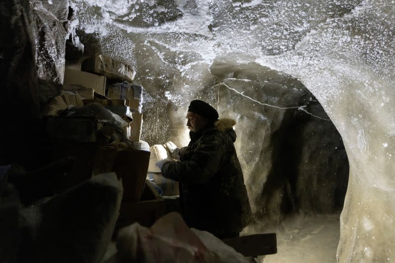 FILE PHOTO: Sergey Zimov, a scientist who works at Russia's Northeast Science Station, checks materials stored underground in the permafrost at the Pleistocene Park outside the town of Chersky