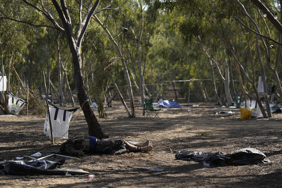 The body of a killed Hamas militant lies on the ground at the site of a music festival, near the border with Gaza Strip in southern Israel, Thursday. Oct. 12, 2023. At least 260 Israeli festivalgoers were killed during the attack last Saturday. (AP Photo/Ohad Zwigenberg)