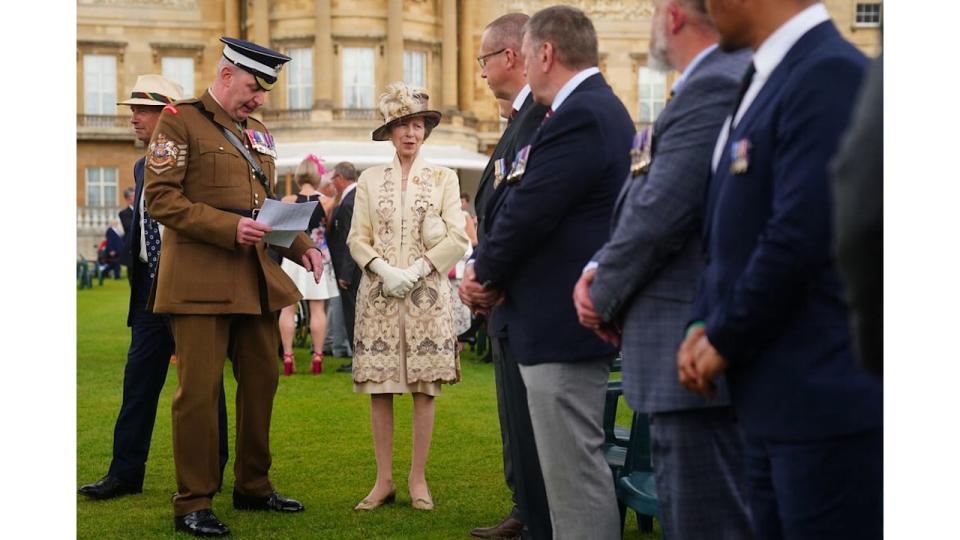 Princess Anne in a cream embroidered dress and feathered hat