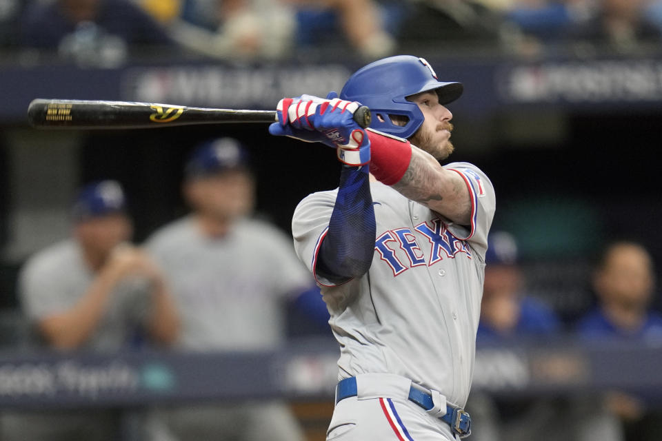 FILE - Texas Rangers' Jonah Heim bats against the Tampa Bay Rays in Game 2 in an AL wild-card baseball playoff series, Oct. 4, 2023, in St. Petersburg, Fla. Heim and six other players agreed to one-year contracts with the Texas Rangers on Thursday, Jan. 11, 2024, avoiding salary arbitration. (AP Photo/John Raoux, File)
