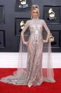 <p>Leave it to Paris Hilton to slay the Grammys red carpet in a deliciously extra naked dress. The star arrived at the awards show overnight wearing a semi-sheer gown covered in glitzy silver embellishment. The dress, designed by Atelier Zuhra, features intricate beaded detailing from the bust down, coupled with a high neck sparkly cape, falling to the floor behind her. Oh, and a pair of matching gloves.</p><p>Paris shared the look on <a href="https://www.instagram.com/p/Cb5-TYDPcil/" rel="nofollow noopener" target="_blank" data-ylk="slk:Instagram" class="link ">Instagram</a>, along with the perfect Rihanna reference in her caption, which reads "Shine Bright like a Diamond. ✨💎👸🏼💎✨ #Grammys 💫"</p><p>As for the beauty side of things, the star went for a mega high ponytail, teamed with a dramatic side part and all-round glowy makeup.</p>