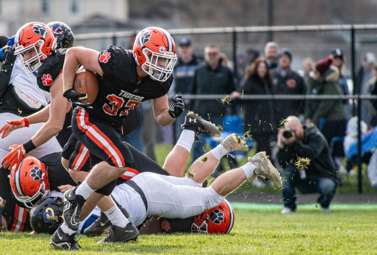 Byron's Caden Considine runs through the line on a 75-yard touchdown run on Byron's first play of the Class 3A quarterfinal playoff game on Saturday, Nov. 11, 2023, at Byron.