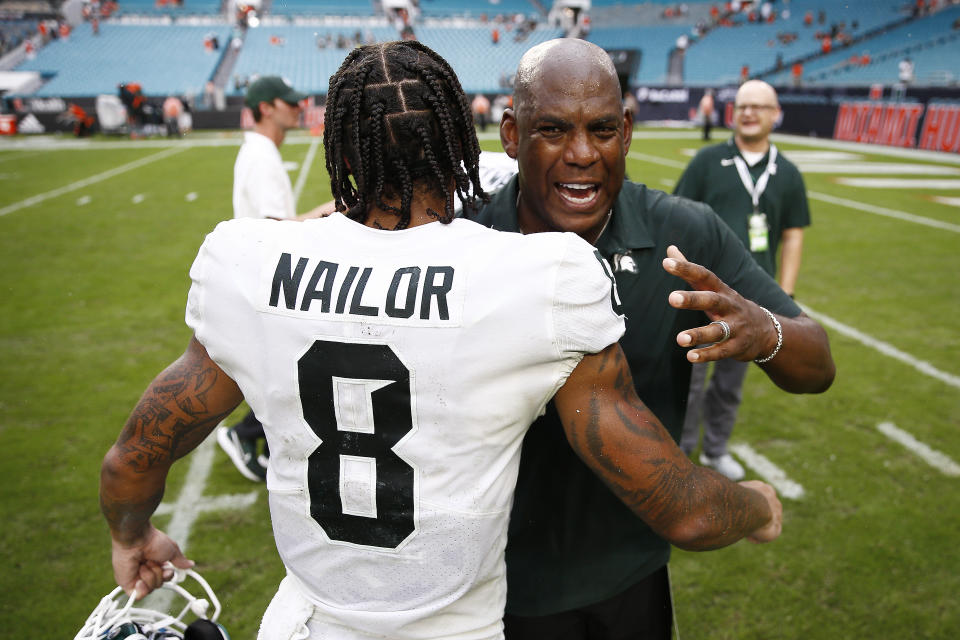 Michigan State head coach Mel Tucker hugs wide receiver Jalen Nailor (8) after they defeated Miami in an NCAA college football game, Saturday, Sept. 18, 2021, in Miami Gardens, Fla. (AP Photo/Michael Reaves)