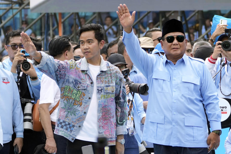FILE - Indonesian Presidential candidate Prabowo Subianto, right, and his running mate Gibran Rakabuming Raka, the eldest son of Indonesian President Joko Widodo, greet supporters during their campaign rally at Gelora Bung Karno Main Stadium in Jakarta, Indonesia, Saturday, Feb. 10, 2024. Indonesians on Wednesday, Feb. 14, 2024 will elect the successor to popular President Joko Widodo, who is serving his second and final term. It is a three-way race for the presidency among current Defense Minister Prabowo Subianto and two former governors, Anies Baswedan and Ganjar Pranowo. (AP Photo/Achmad Ibrahim, File)