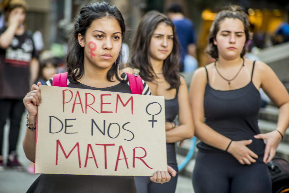 Women in Sao Paulo, Brazil protest with a sign that says, "Stop Killing Us."&nbsp;