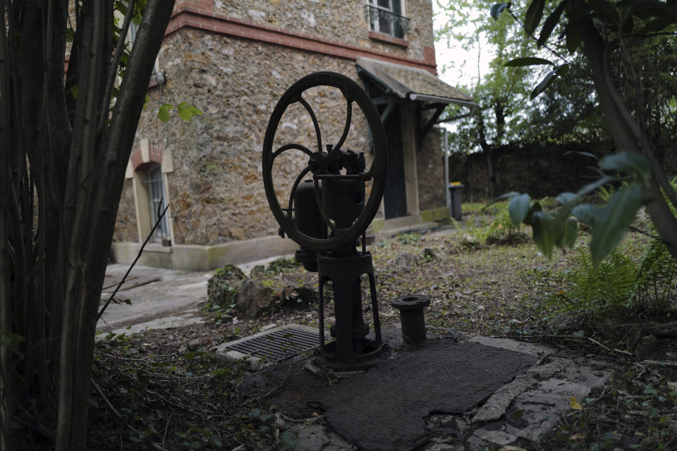 The manual pump of a water well in the garden of the 120 sq. meters (1,300 sq. feet) stone house where the Nobel-winning scientist couple Marie Sklodowska-Curie and Pierre Curie spent vacation and weekends from 1904-1906 in Saint-Remy-les-Chevreuse, on the south-west outskirts of Paris, France, Wednesday, May 12, 2021. Poland's prime minister Mateusz Morawiecki says he's given instructions for the government to buy 790,000 euro house in France, and said on Twitter Tuesday that the house, is a "part of Poland's history." (AP Photo/Francois Mori)