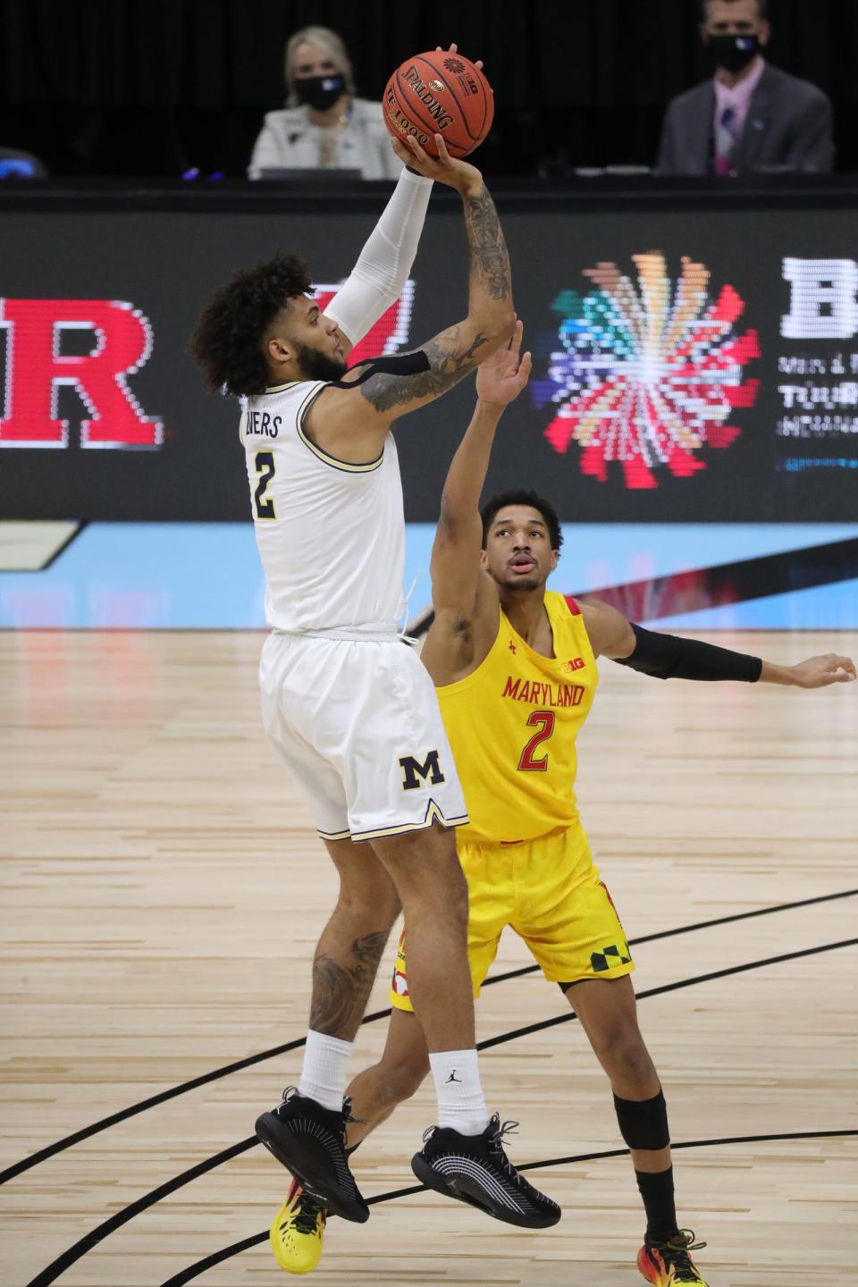 Michigan Wolverines forward Isaiah Livers shoots against Maryland Terrapins guard Aaron Wiggins during the Big Ten tournament quarterfinals Friday, March 12, 2021 at Lucas Oil Stadium in Indianapolis.