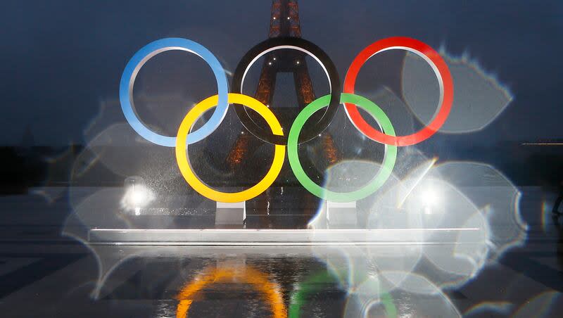 The reflection of the Olympic rings on Trocadero plaza that overlooks the Eiffel Tower in Paris, France, Wednesday, Sept. 13, 2017. The IOC has said it might delay a final award of the 2030 Winter Olympics to France.